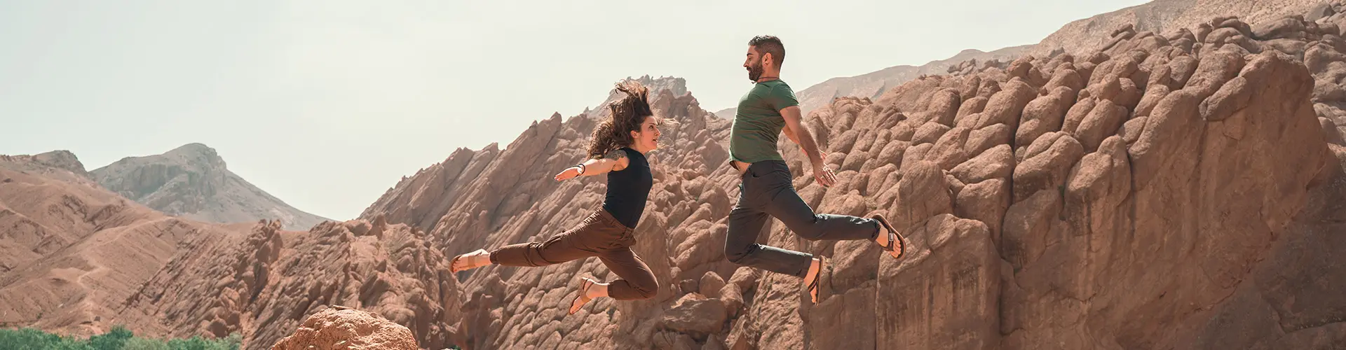Couple jumping at Monkey Fingers, Morocco